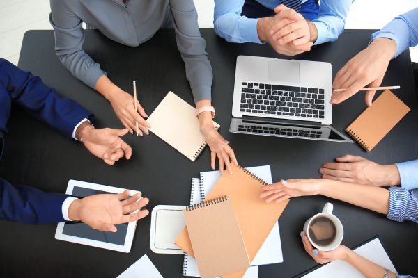 team of accountants at their desk with laptops, working.