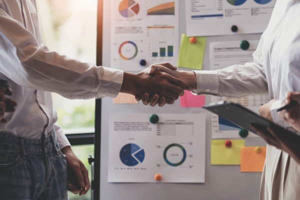 business-handshake-for-teamwork-of-business-merger-2023-11-27-05-25-20-utc-scaled