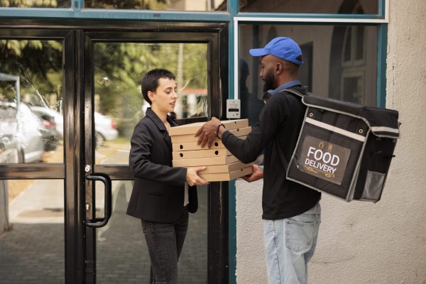 pizzeria-courier-giving-customer-pizza-order-outdo-2023-11-27-05-07-32-utc